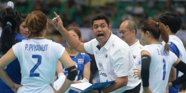 TIANJIN, CHINA - MAY 27: (CHINA OUT) Kiattipong Radchatagriengkai, head coach of Thailand, speaks to players in the semi-finals on day eight of the 18th Asian Sr. Women's Volleyball Championship at Tianjin Olympic Center Stadium on May 27, 2015 in Tianjin, China. (Photo by VCG/VCG via Getty Images)