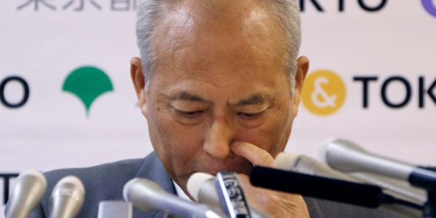 Tokyo Gov. Yoichi Masuzoe scratches his nose reporters questions during a press conference in Tokyo, Friday, May 13, 2016. The governor Tokyo has triggered public outrage for flying first-class and staying at up to $1,800-a-night suites in Europe and America during official overseas trips. (AP Photo/Koji Sasahara)