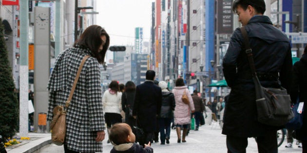 A family walks through the Ginza district of Tokyo, Japan, on Monday, Feb. 15, 2010. Japan's economic growth accelerated last quarter as a global trade revival fueled demand for the nation's exports. Photographer: Kimimasa Mayama/Bloomberg via Getty Images