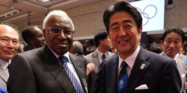 BUENOS AIRES, ARGENTINA - SEPTEMBER 07: Prime Minister of Japan Shinzo Abe shakes hands with IOC Member Lamine Diack as Tokyo is awarded the 2020 Summer Olympic Gamesduring the 125th IOC Session - 2020 Olympics Host City Announcement at Hilton Hotel on September 7, 2013 in Buenos Aires, Argentina. (Photo by Ian Walton/Getty Images)