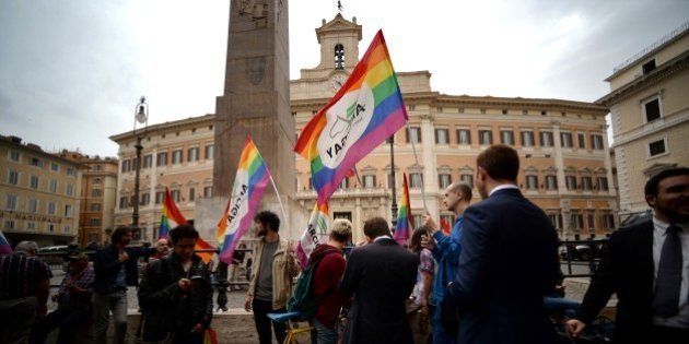 Supporters of same-sex civil unions stand outside the Italian Parliament in Rome on May 11, 2016. Italy's parliament gave a green light for the introduction of gay civil unions in the last major Western country not to legally recognise same-sex relationships. Lawmakers in the lower-house Chamber of Deputies voted 369-193 in favour of a vote of confidence in the government which makes final approval of the divisive civil unions bill automatic / AFP / FILIPPO MONTEFORTE (Photo credit should read FILIPPO MONTEFORTE/AFP/Getty Images)