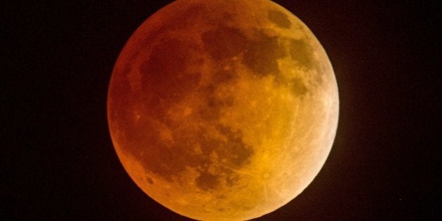 Total eclipse of the moon underway over southern California as seen from Korea town ,west of downtown Los Angeles ,early on April 15, 2014. The entire event was to be visible from North and South America, but sky watchers in northern and and eastern Europe, eastern Africa, the Middle East and Central Asia were out of luck, according to NASA.AFP PHOTO/JOE KLAMAR (Photo credit should read JOE KLAMAR/AFP/Getty Images)