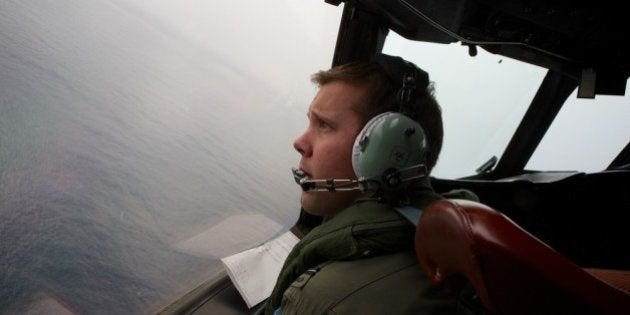 IN FLIGHT - MARCH 24: Co-Pilot, Flying Officer Marc Smith looks out as he turns his RAAF AP-3C Orion aircraft at low level in bad weather while searching for missing Malaysia Airways Flight MH370 on March 24, 2014 off the South West Coast of Perth, Australia. Malaysian Prime Minister Najib Razak spoke at a press conference today to announce that fresh analysis of available satellite data has concluded that missing flight MH370's final position was in the southern Indian Ocean. French authorities reported a satellite sighting of objects in an area of the southern Indian Ocean where China and Australia have also reported similar sightings of potential debris from the flight that went missing on March 8. (Photo by Richard Wainwright - Pool/Getty Images)