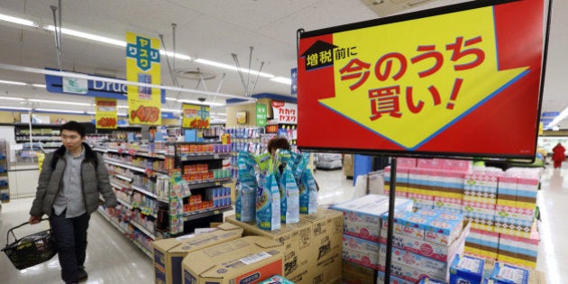 Signage displays sale prices as customers shop at a Seiyu GK supermarket, a discount chain owned by Wal-Mart Stores Inc., in Tokyo, Japan, on Thursday, March, 13, 2014. Companies and consumers have rushed to make purchases before April, with industrial production rising the most in January since June 2011 and retail sales gaining at the fastest pace since April 2012. Photographer: Tomohiro Ohsumi/Bloomberg via Getty Images