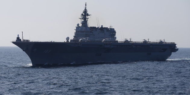 The Izumo military helicopter carrier of the Japan Maritime Self-Defense Force (JMSDF) sails during its fleet review at Sagami Bay, off Yokosuka, south of Tokyo October 18, 2015. REUTERS/Toru Hanai