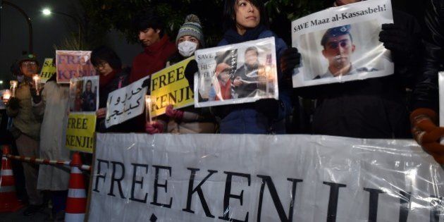 Demonstrators stage a rally to demand to free a Japanese hostage Kenji Goto who has been kidnapped by the Islamic State group in front of the Prime Minister's official residence in Tokyo on January 30, 2015. The Japanese public has rallied around Goto, a respected war reporter and humanitarian. Though they largely support Prime Minister Shinzo Abe's handling of the crisis, that may change if the journalist does not come home alive. AFP PHOTO / Yoshikazu TSUNO (Photo credit should read YOSHIKAZU TSUNO/AFP/Getty Images)