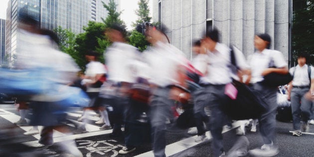 Crowds of high school students rushing home after school. High key.