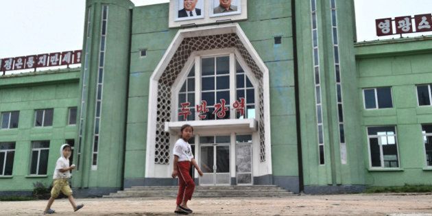 TUMANGANG, NORTH KOREA - AUGUST 19: Kids pass by Tumangang railway station on August 19, 2015 in Tumangang, North Korea. North and South Korea today came to an agreement to ease tensions following an exchange of artillery fire at the demilitarized border last week. (Photo by Xiaolu Chu/Getty Images)