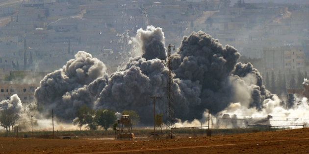 SANLIURFA, TURKEY - OCTOBER 28: (TURKEY OUT) An explosion following an air-strike in the Syrian town of Kobani from near the Mursitpinar border crossing on the Turkish-Syrian border in the southeastern town of Suruc in Sanliurfa province October 28, 2014. It has been reported that 150 Iraqi peshmerga from Iraq's northern Kurdistan region, armed with American weapons, are expected to arrive in Turkey later today following authorization of their deployment last week. The Iraqi peshmerga fighters will fly into Turkey and travel by land across the Syrian border to provide logistical and artillery support to their Syrian counterparts, but will not be involved in frontline combat. (Photo by Kutluhan Cucel/Getty Images)