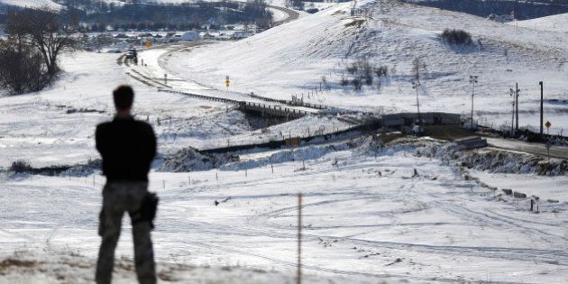A police officer monitors the outskirts of the Dakota Access oil pipeline protest camp near Cannon Ball, North Dakota, U.S., January 29, 2017. REUTERS/Terray Sylvester