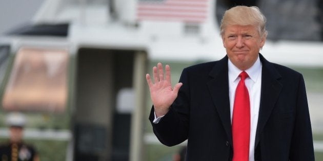 US President Donald Trump makes his way to board Air Force One before departing from Andrews Air Force Base in Maryland, bound for Palm Beach, Florida on February 3, 2017. / AFP / MANDEL NGAN (Photo credit should read MANDEL NGAN/AFP/Getty Images)