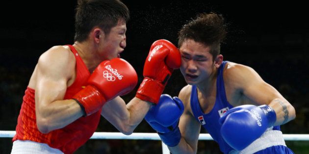 2016 Rio Olympics - Boxing - Preliminary - Men's Bantam (56kg) Round of 16 Bout 191 - Riocentro - Pavilion 6 - Rio de Janeiro, Brazil - 14/08/2016. Zhang Jiawei (CHN) of China and Ham Sang-Myeong (KOR) of South Korea compete. REUTERS/Peter Cziborra FOR EDITORIAL USE ONLY. NOT FOR SALE FOR MARKETING OR ADVERTISING CAMPAIGNS.