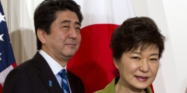 South Korean President Park Geun-hye and Japanese Prime Minister Shinzo Abe arrive for a trilateral meeting with the US presidentat the US ambassador's residence in The Hague on March 25, 2014 after they attended the Nuclear Security Summit (NSS). US President Barack Obama hosted the much-anticipated first meeting between the Asian leaders with relations between Tokyo and Seoul at their lowest ebb in years, mired in emotive issues linked to Japan's 1910-45 colonial rule and a territorial dispute