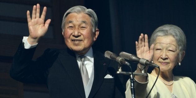 Japanese Emperor Akihito (L) and Empress Michiko (R) wave to well-wishers on the balcony of the Imperial...