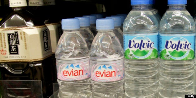 Bottles of Evian and Volvic water produced by Danone are displayed next to bottles of Suntory Holdings Ltd. tea at a convenience store in Tokyo, Japan, on Tuesday, Oct. 18, 2011. Danone, the owner of the Evian and Volvic bottled-water brands, is in talks to sell water assets to Japan's Suntory Holdings Ltd., said three people familiar with the matter. Photographer: Koichi Kamoshida/Bloomberg via Getty Images