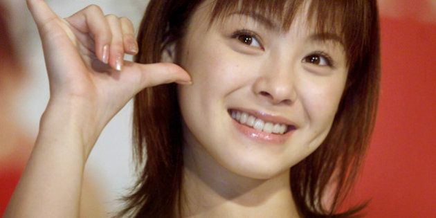Japanese pop singer Aya Matsuura poses for photographers during apromotion event in Taipei May 13, 2002. Matsurra, 16, is a member ofthe music group