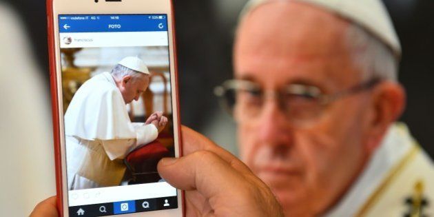 A man looks at the Instagram account of Pope Francis (Franciscus) on March 19, 2016 in Rome. The date for the pontiff's debut on the celebrity-dominated social medium was chosen by the 79-year-old himself as it marks the third anniversary of his inauguration as the leader of the world's 1.2 billion Catholics. / AFP / GABRIEL BOUYS (Photo credit should read GABRIEL BOUYS/AFP/Getty Images)