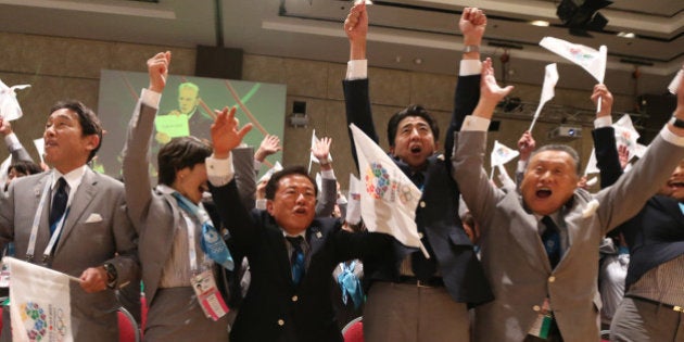 Japan's Prime Minister Shinzo Abe, fourth from left, and Tokyo's Governor Naoki Inose, third from left, celebrate with other members of the Tokyo delegation after the International Olympic Committee President Jacques Rogge announced that Tokyo will host the 2020 Olympic Games during the 125th IOC session in Buenos Aires, Argentina, Saturday, Sept. 7, 2013. Tokyo defeated Istanbul in the final round of secret voting Saturday by the International Olympic Committee. Madrid was eliminated earlier after an initial tie with Istanbul. (AP Photo/Ian Watson, Pool)