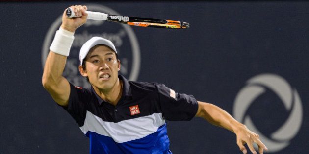 MONTREAL, ON - AUGUST 13: Kei Nishikori of Japan hits a return against David Goffin of Belgium during day four of the Rogers Cup at Uniprix Stadium on August 13, 2015 in Montreal, Quebec, Canada. Kei Nishikori defeated David Goffin 6-4, 6-4. (Photo by Minas Panagiotakis/Getty Images)
