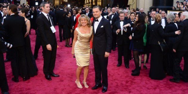 Nominee for Best Actor in 'The Wolf of Wall Street' Leonardo DiCaprio arrives with his mother Irmelin for the 86th Academy Awards on March 2nd, 2014 in Hollywood, California. AFP PHOTO FREDERIC J. BROWN (Photo credit should read FREDERIC J. BROWN/AFP/Getty Images)