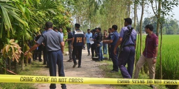 Bangladeshi police officials stand guard at the site where a Japanese citizen was shot to death by attackers in Rangpur on October 3, 2015. A Japanese citizen was shot dead by gunmen in a northern Bangladesh town onOctober 3, police said, days after an Italian aid worker was murdered in an attack claimed by the Islamic State group. Police said the victim, whom they named as Hoshi Kunio, aged 66, was riding in a rickshaw when he was shot dead in Kaunia town in the Rangpur district at about 10:30 am local time (0430 GMT). AFP PHOTO / STR (Photo credit should read STRINGER/AFP/Getty Images)