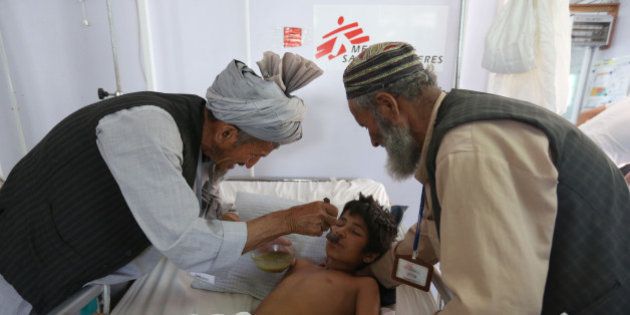 In this Wednesday, May 20, 2015 photo, an Afghan boy is fed as he recovers at a Medecins Sans Frontieres (MSF) hospital in Kunduz province, north of Kabul, Afghanistan. When the Taliban descended a month ago on Dam Shakh, a hamlet on the wheat-growing plains of northern Afghanistanâs Kunduz province, nobody was prepared. By the time they were beaten back from the provincial capital of Kunduz, more than 100,000 people were forced from their homes and total of 204 war-wounded were admitted to Kunduzâs only trauma hospital, run by French NGO, MSF in less than a month. (AP Photo/Rahmat Gul)