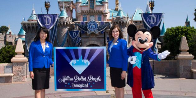ANAHEIM, CA - JULY 17: In this handout photo provided by Disney parks, MILLION DOLLAR DAZZLE - Mickey Mouse and the 2015 Disneyland Resort Ambassadors celebrate the exciting new philanthropic program, 'Million Dollar Dazzle,' announced during a ceremony celebrating the 60th anniversary of Disneyland park July 17, 2015 in Anaheim, California. Each month during the Disneyland Resort Diamond Celebration, the Million Dollar Dazzle Crew will surprise one or more local nonprofits that exemplify Walt Disney Parks and Resorts Better Together philosophy with a $60,000 gift, totaling more than $1 million. Celebrating six decades of magic, the Disneyland Resort Diamond Celebration features three new nighttime spectaculars that immerse guests in the worlds of Disney stories like never before with 'Paint the Night,' the first all-LED parade at the resort; 'Disneyland Forever,' a reinvention of classic fireworks that adds projections to pyrotechnics to transform the park experience; and a moving new version of 'World of Color' that celebrates Walt Disneys dream for Disneyland. (Photo by Paul Hiffmeyer/Disneyland Resort via Getty Images)