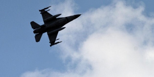 A Turkish fighter jet flies above the Incirlik airbase, southern Turkey, Saturday, Aug. 31, 2013. U.N. chemical weapons experts have left Syria and crossed into neighboring Lebanon. The team on Friday carried out a fourth and final day of inspection as they sought to determine precisely what happened in the Aug. 21 alleged chemical weapons attack near Damascus. The team took samples from victims for examination in laboratories in Europe. (AP Photo/Vadim Ghirda)