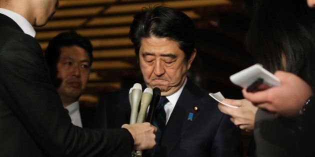 Japanese Prime Minister Shinzo Abe speakes to reporters after a cabinet meeting at his official residence in Tokyo on January 25, 2015. Japan's government said it was attempting to verify a video posted online announcing the execution of one of two Japanese hostages held captive by Islamic State militants. 'A new video apparently showing Kenji (Goto) was posted on the Internet,' chief government spokesman Yoshihide Suga said. 'We are collecting information'. AFP PHOTO / Yoshikazu TSUNO (Photo credit should read YOSHIKAZU TSUNO/AFP/Getty Images)