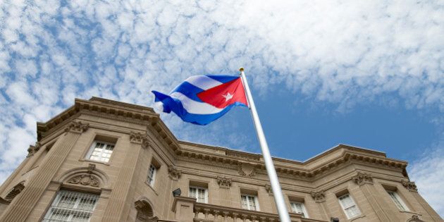 The Cuban flag is raised over their new embassy in Washington, Monday, July 20, 2015. Cuba's blue, red and white-starred flag was hoisted Monday at the country's embassy in Washington in a symbolic move signaling the start of a new post-Cold War era in U.S.-Cuba relations. (AP Photo/Andrew Harnik, Pool)