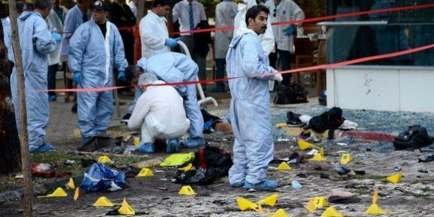 Turkish forensic investigators work at the site of a suicide bombing which killed at least 31 on July 20, 2015 in the Turkish town of Suruc near the border with Syria. A suspected Islamic State suicide bomber killed at least 31 people on July 20 in an attack on a Turkish cultural centre where activists had gathered to prepare for an aid mission in the nearby Syrian town of Kobane. AFP PHOTO / ILYAS AKENGIN (Photo credit should read ILYAS AKENGIN/AFP/Getty Images)