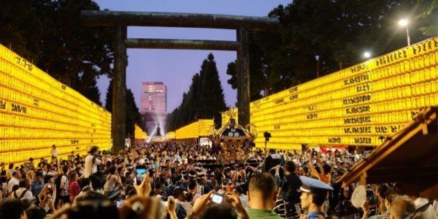 A portable shrine is carried past rows of lit lanterns during the Mitama Matsuri festival at the Yasukuni Shrine in Tokyo on July 13, 2015. Some 30,000 lanterns were illuminated in the precinct in memory of victims of war. AFP PHOTO / KAZUHIRO NOGI (Photo credit should read KAZUHIRO NOGI/AFP/Getty Images)