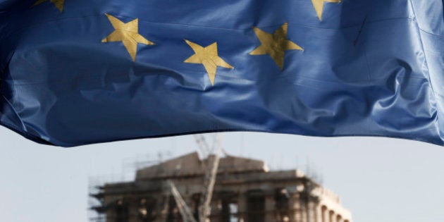 A European Union flag billows in the wind as the ruins of the 5th century BC Parthenon temple is seen in the background on the Acropolis hill, in Athens, Friday, Jan. 23, 2015. Prime Minister Antonis Samaras' New Democracy party has failed so far to overcome a gap in opinion polls with the anti-bailout Syriza party ahead of the Jan. 25 general election. (AP Photo/Petros Giannakouris)