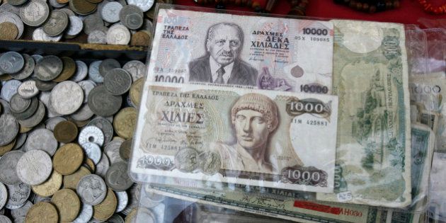 Old Greek drachma coins and notes sit arranged for sale during an antique bazaar at the northern port city of Thessaloniki Greece on Sunday, Oct. 21 2012. (AP Photo/Nikolas Giakoumidis)