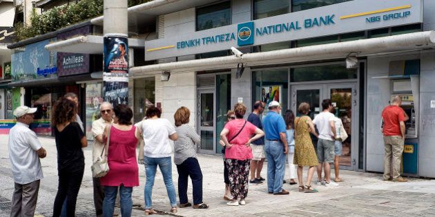 ATHENS, GREECE - JUNE 28: Greeks queue in front of the National Bank to use ATM to withdraw cash on June 28, 2015 in Athens, Greece. Greece is anxiously awaiting a decision by the European Central Bank on whether to increase the emergency liquidity assistance banks can draw on from the country's central bank. (Photo by Milos Bicanski/Getty Images)