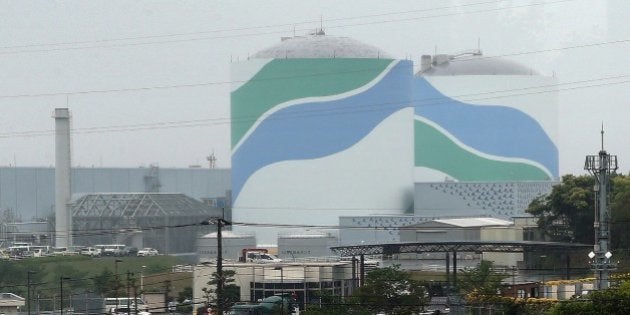 This picture taken on April 28, 2014 shows the Sendai nuclear power plant in Kagoshima prefecture. Japan's nuclear regulator said on July 16 that two atomic reactors were safe enough to switch back on, marking a major step towards restarting atomic plants that were shuttered after the Fukushima crisis. Nuclear Regulatory Authority (NRA) officials issued a more than 400 page report on the Sendai plant in southern Japan, technically giving its operator the green light to switch on its reactors -- the first since Japan ushered in tougher safety guidelines last year. JAPAN OUT AFP PHOTO / JIJI PRESS (Photo credit should read JIJI PRESS/AFP/Getty Images)