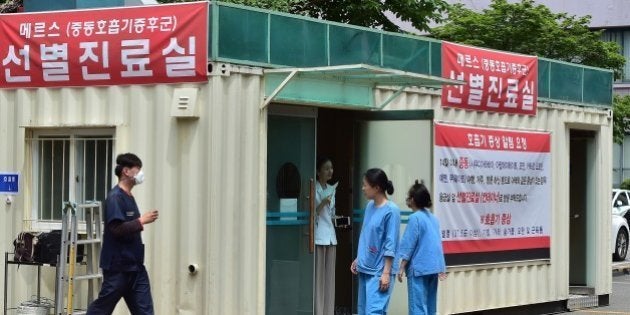 South Korean hospital workers set a separated emergency center for MERS cases at the National Medical Center in Seoul on June 1, 2015. South Korean President Park Geun-Hye scolded health officials on June 1, over their response to an outbreak of the MERS virus, as the number of infections climbed to 18, with nearly 700 under observation. Major South Korean hospitals are setting up special MERS clinic rooms to fight the disease. AFP PHOTO / JUNG YEON-JE (Photo credit should read JUNG YEON-JE/AFP/Getty Images)