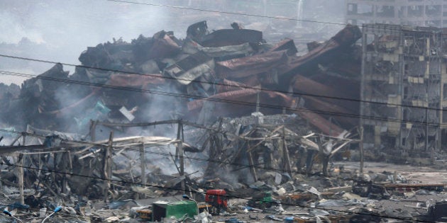 Deformed containers pile up at the site of an explosion at a warehouse in northeastern China's Tianjin municipality, Friday, Aug. 14, 2015. Explosions that sent huge fireballs through China's Tianjin port have disrupted the flow of cars, oil, iron ore and other items through the world's 10th largest port. (AP Photo/Ng Han Guan)