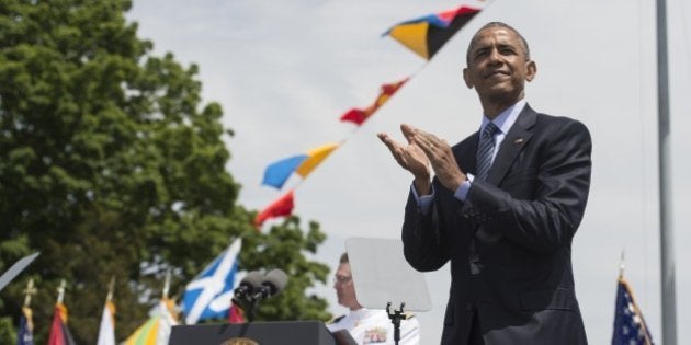 US President Barack Obama applauds at the end of the 134th Commencement Exercises of the United States Coast Guard Academy in New London, Connecticut, on May 20, 2015. AFP PHOTO/NICHOLAS KAMM (Photo credit should read NICHOLAS KAMM/AFP/Getty Images)