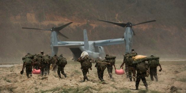 Nepalese soldiers prepare to board one of U.S. Ospreys which is used to deploy them in the quake affected mountainous areas in Manthali, Nepal, Thursday, May 7, 2015. The April 25 earthquake killed thousands and injured many more as it flattened mountain villages and destroyed buildings and archaeological sites in Kathmandu.(AP Photo/Bernat Armangue)