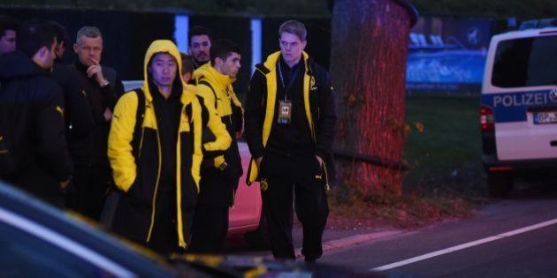 Police escort Dortmund's players after the team bus of Borussia Dortmund had some windows broken by an explosion some 10km away from the stadium prior to the UEFA Champions League 1st leg quarter-final football match BVB Borussia Dortmund v Monaco in Dortmund, western Germany on April 11, 2017. / AFP PHOTO / PATRIK STOLLARZ (Photo credit should read PATRIK STOLLARZ/AFP/Getty Images)