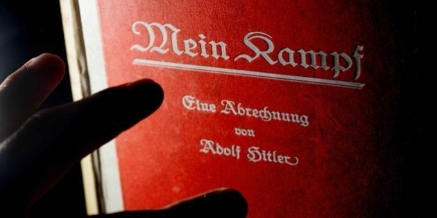 A signed copy of a first edition of Adolf Hitler's book Mein Kampf goes on display at Bloomsbury auction house, London, 14 June 2005. The lot also features a signed photograph of the Nazi leader and pictures of his meeting with British Prime Minister Neville Chamberlin in September 1938 and sheets of embossed Nazi stationary paper. The lot is expected to fetch up to £25 000, (37 000 Euros). (Photo credit should read CARL DE SOUZA/AFP/Getty Images)