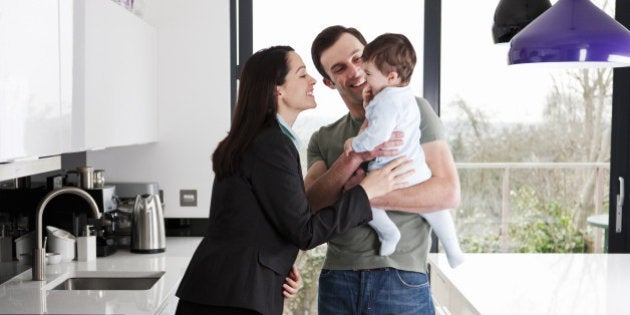 A working mother greeting her partner and baby son