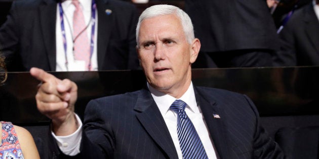 Vice Presidential nominee Gov. Mike Pence of Indiana points as he sits during the second day session of the Republican National Convention in Cleveland, Tuesday, July 19, 2016. (AP Photo/John Locher)