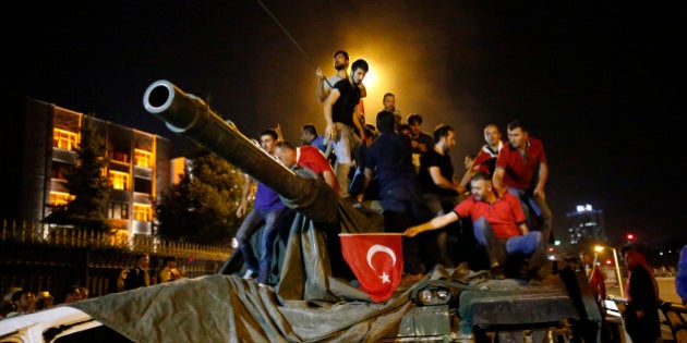 People stand on a Turkish army tank in Ankara, Turkey July 16, 2016. REUTERS/Tumay Berkin