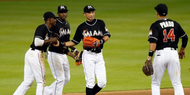 MIAMI, FL - APRIL 25: Ichiro Suzuki #51 of the Miami Marlins celebrates with teammates after breaking the record for the most runs scored by a Japanese player and their win against the Washington Nationals at Marlins Park on April 25, 2015 in Miami, Florida. (Photo by Eliot J. Schechter/Getty Images)