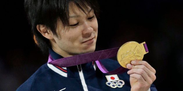 Japanese gymnast Kohei Uchimura holds his gold medal during the medal ceremony of the Artistic Gymnastic men's individual all-around competition at the 2012 Summer Olympics, Wednesday, Aug. 1, 2012, in London. (AP Photo/Julie Jacobson)