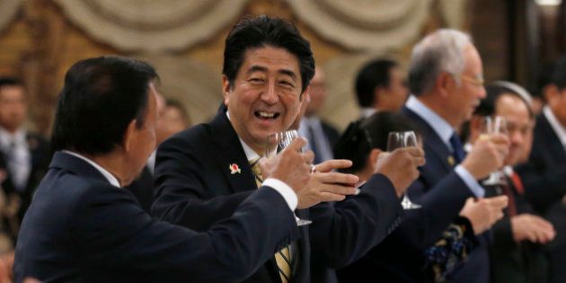 Japanese Prime Minister Shinzo Abe, second from left, raises a toast with Brunei's Sultan Hassanal Bolkiah, left, and other ASEAN leaders during a welcome dinner of Japan-ASEAN commemorative summit hosted by Abe and his wife at the Abe's official residence in Tokyo, Friday, Dec. 13, 2013. Seen at right is Malaysian Prime Minister Najib Razak. (AP Photo/Shizuo Kambayashi, Pool)