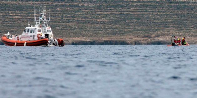 Italian Coast Guard personnel recover a body bag on their patrol boat in Lampedusa island, Italy, Tuesday, Oct. 8, 2013. Italian divers have recovered more bodies from the wreck of a smuggler's ship that sank off the tiny island of Lampedusa, raising the death toll to 250. Coast Guard Commander Filippo Marini said 18 bodies were recovered Tuesday from within the ship's hold, while one was spotted by a helicopter floating nearby the wreck. Marini said the search would continue as long as weather allows. Just 155 migrants, most if not all from Eritrea, survived last Thursday's shipwreck. Survivors said there were some 500 people on board when the ship capsized and sank in sight of land. A disproportionate number of the dead are women: So far the bodies of 75 women have been recovered, while only six of the survivors were female. Seven of the dead are children. (AP Photo/Francesco Malavolta)