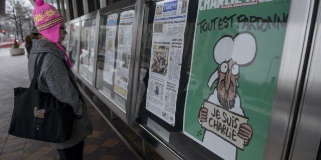 The cover of the French satirical newspaper Charlie Hebdo featuring the Prophet Mohammed is seen displayed with front pages for newspapers from around the world outside the Newseum January 14, 2015 in Washington, DC. French President Francois Hollande proclaimed Wednesday that 'Charlie Hebdo is alive and will live on,' after the satirical weekly published its first edition since Islamist gunmen attacked its Paris offices and killed 12 people. AFP PHOTO/BRENDAN SMIALOWSKI (Photo credit should read BRENDAN SMIALOWSKI/AFP/Getty Images)
